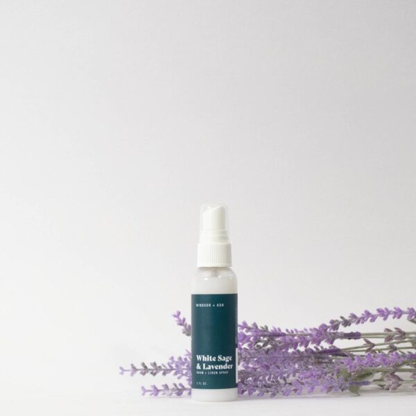 Windsor + Ash White Sage & Lavender room and linen spray bottle with lavender sprigs on a white background.